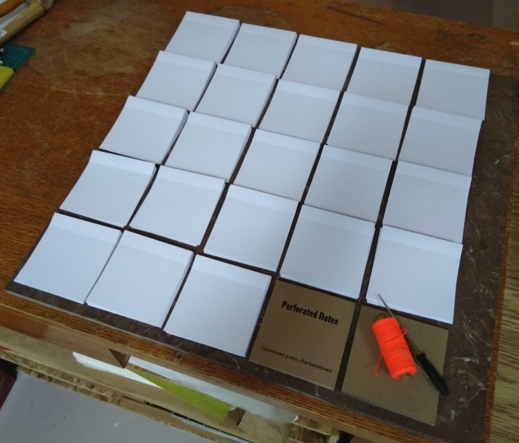 Photo of the parts for 23 notebooks ready for assembly.
