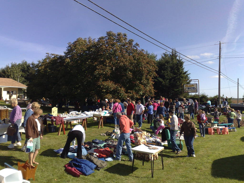 70 Mile Coast Yard Sale tables along the highway, with crowds of people