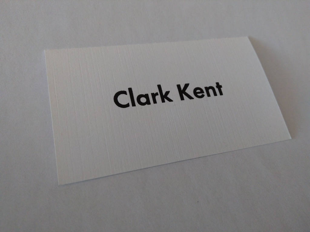 Clark Kent business card on textured paper