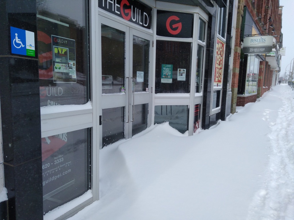 Photo of the front entrance of The Guild covered in snow.