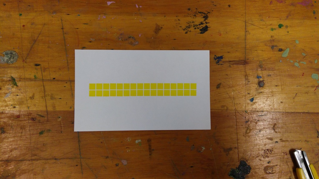 Photo of a single index card printed in yellow with squares