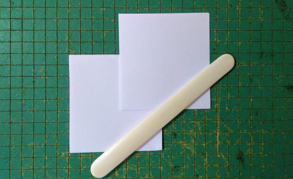 Photo of folded pieced, with bone folder.