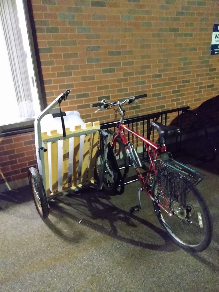 My bike and my trailer locked to the rack at the airport.
