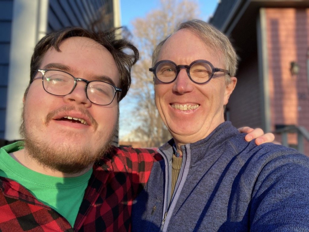 Photo of me and Oliver in the Christmas Eve sun, in front of our house.