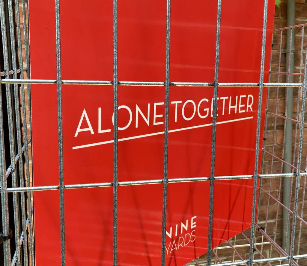 Alone Together sign, in a cage.