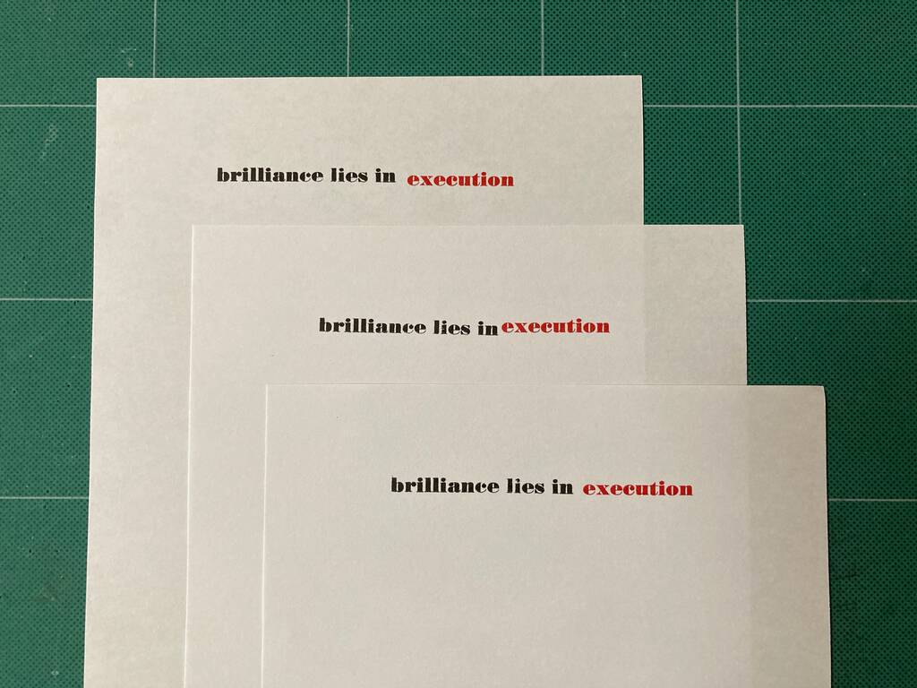 Photo of 'brilliance lies in execution' tests, with imperfect colour registration between black and read