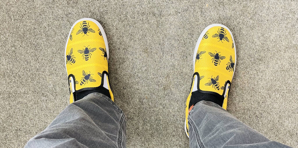 My new yellow shoes, against a grey carpet background.