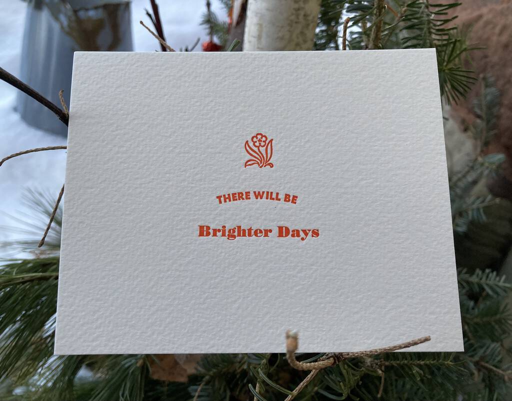 "There Will Be Brighter Days" letterpress print, sitting in a bush.