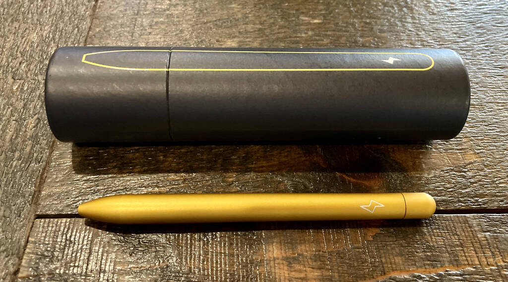 Baron Fig Bolt pen tube and the pen itself, a matte anodized yellow retracted ballpoint.