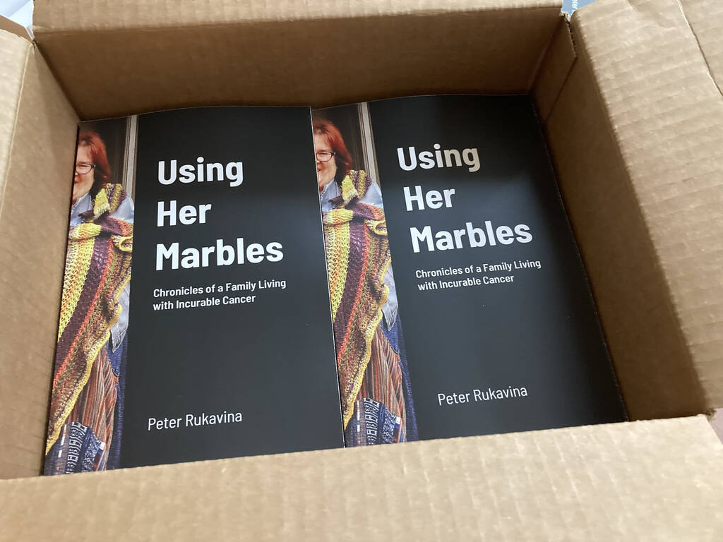 A box of the Using Her Marbles book.