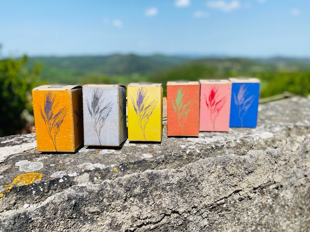A group of our Serrazzano boxes, in different colours, finished and in the sun on a stone wall.