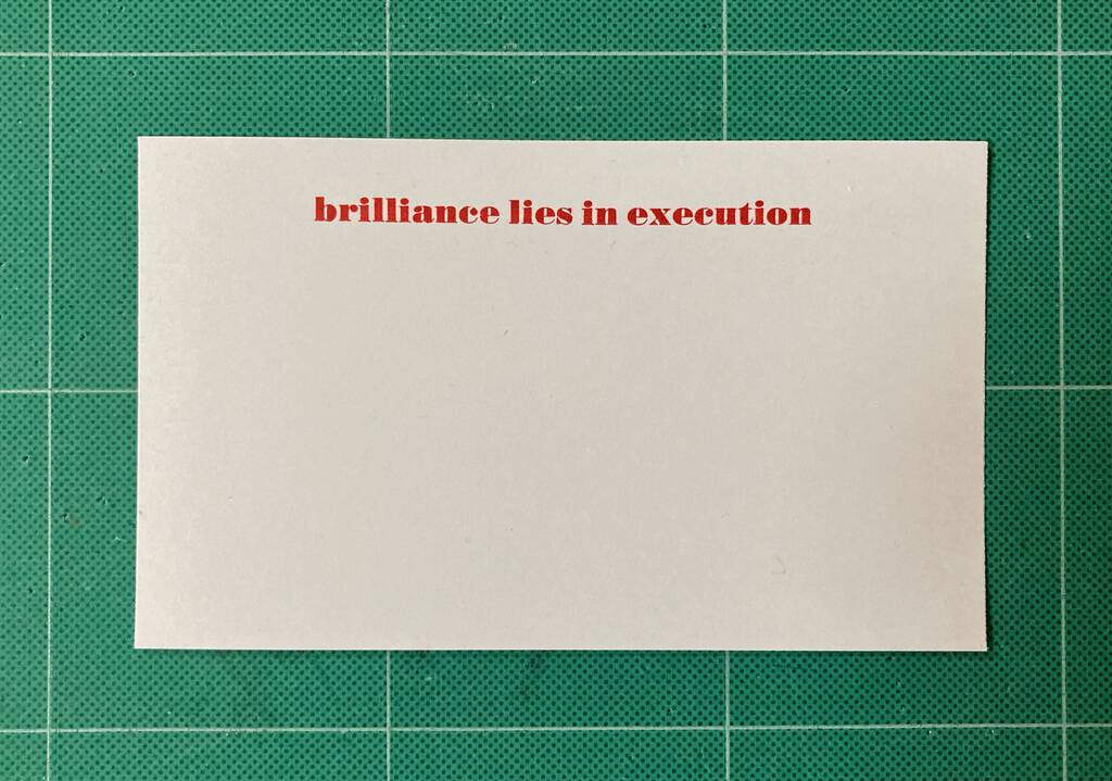 Brilliance lies in execution notecard, in red.