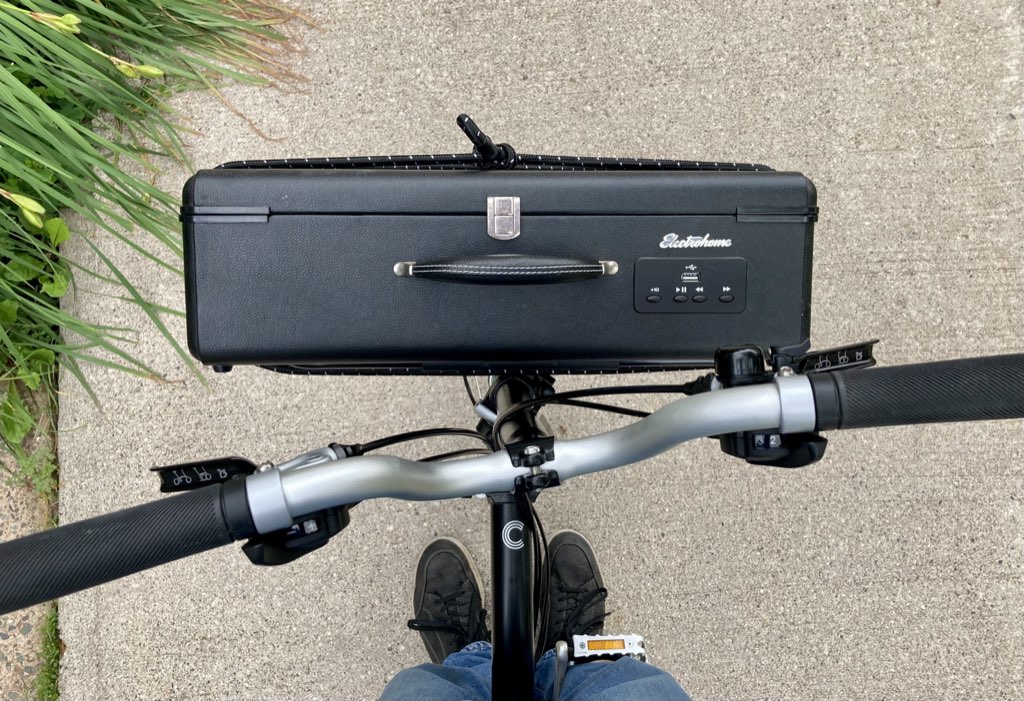 An Electrohome record player strapped to my Brompton bicycle front rack.