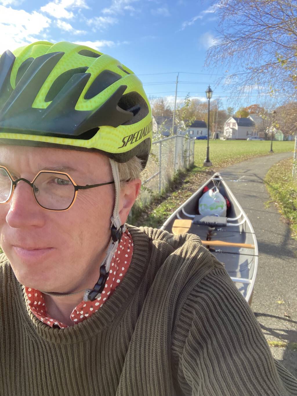 Selfie from my bicycle, showing my canoe towed behind me.