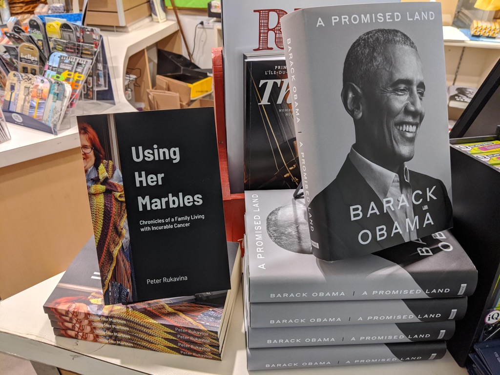 Book table at The Bookmark, showing Using Her Marbles beside Barack Obama's  A Promised Land