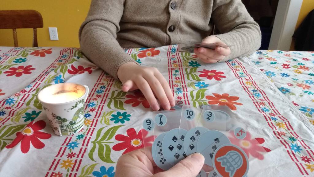 Photo of me and Oliver playing Crazy 8s at the dining room table.