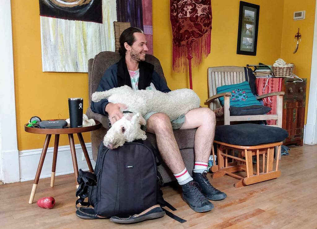 Derrick with Ethan the Dog on his lap.