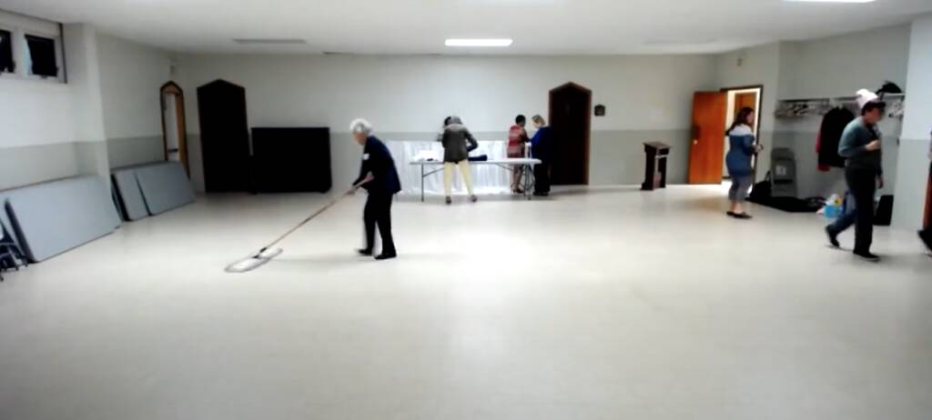 Dorothy Forsythe sweeping the floor in St. Paul's Parish Hall