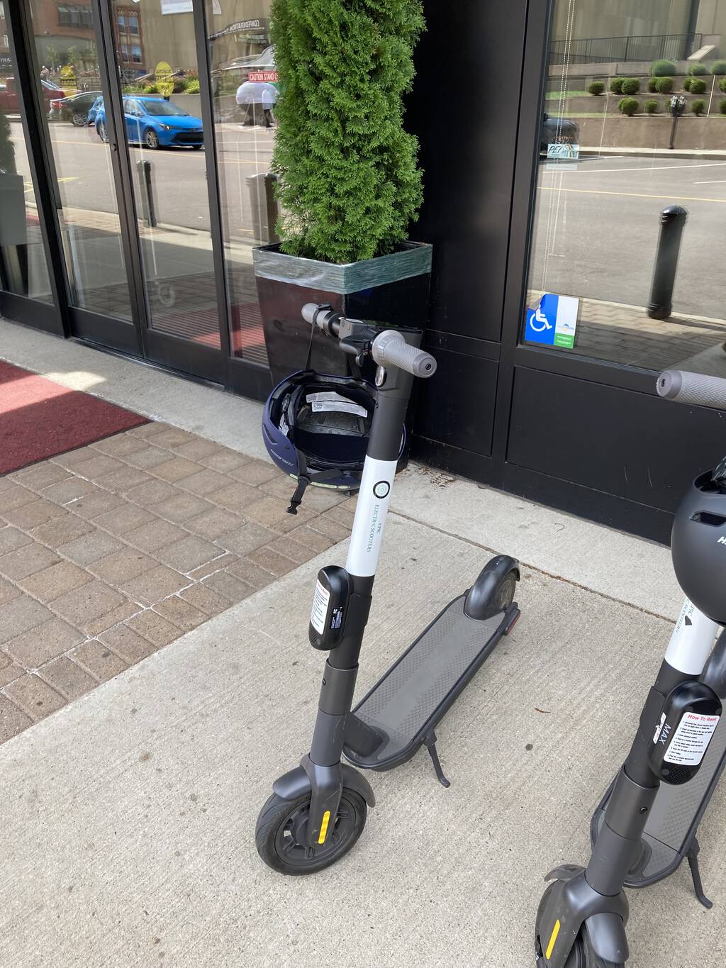 Photo of an Epic Electric Scooter parking in front of the Holman Grand Hotel.