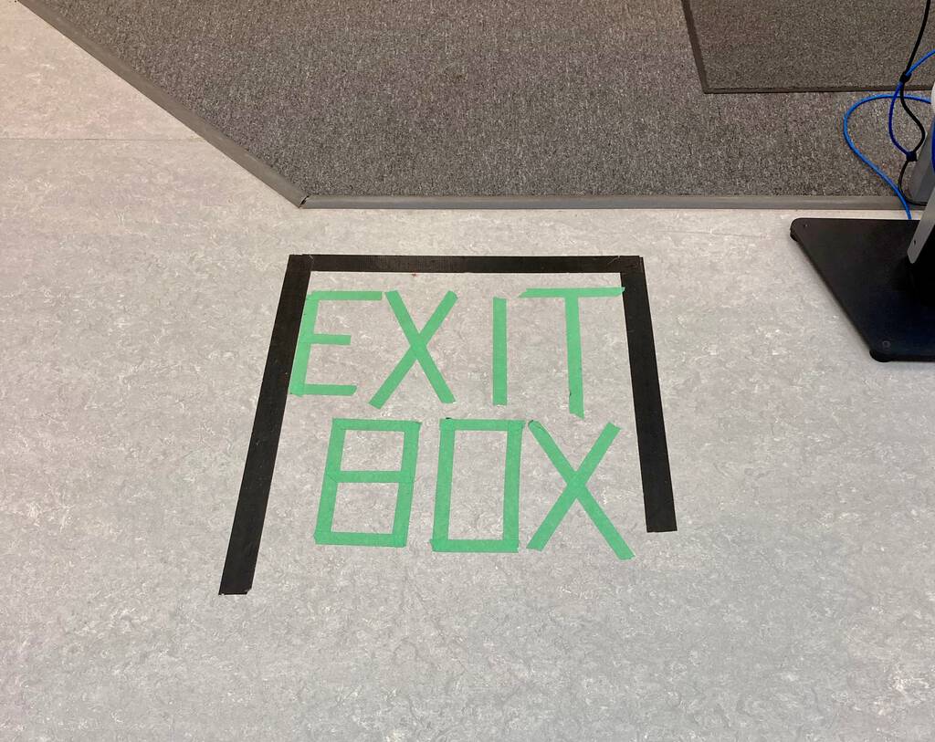 Photo of "Exit Box" sign on the floor, in painter's tape, at Canadian Blood Services.