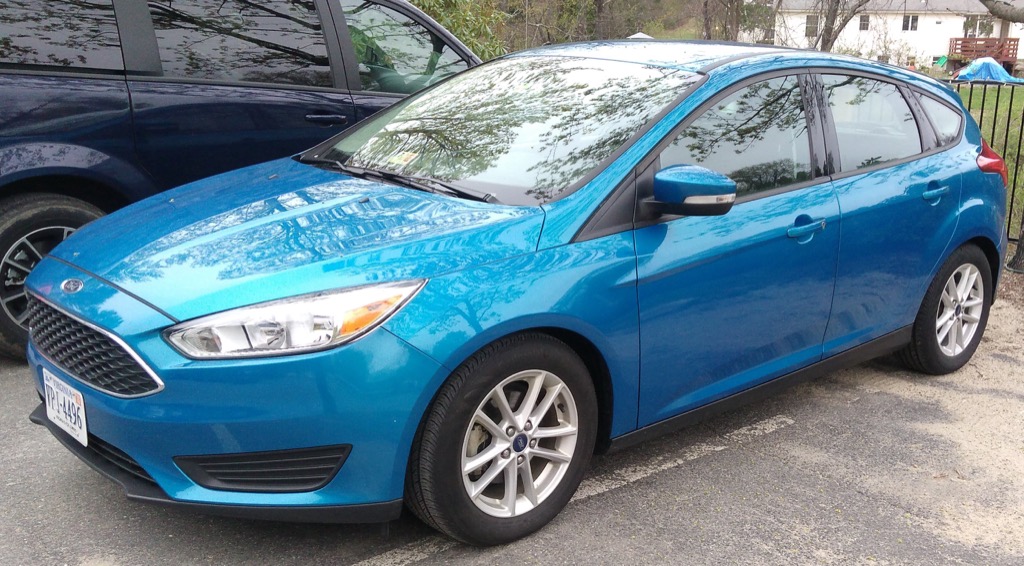 Photo of a blue Ford Focus rented from Hertz, taken from the side.