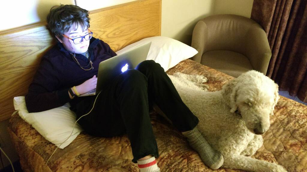 Ethan and Oliver at a hotel, computing