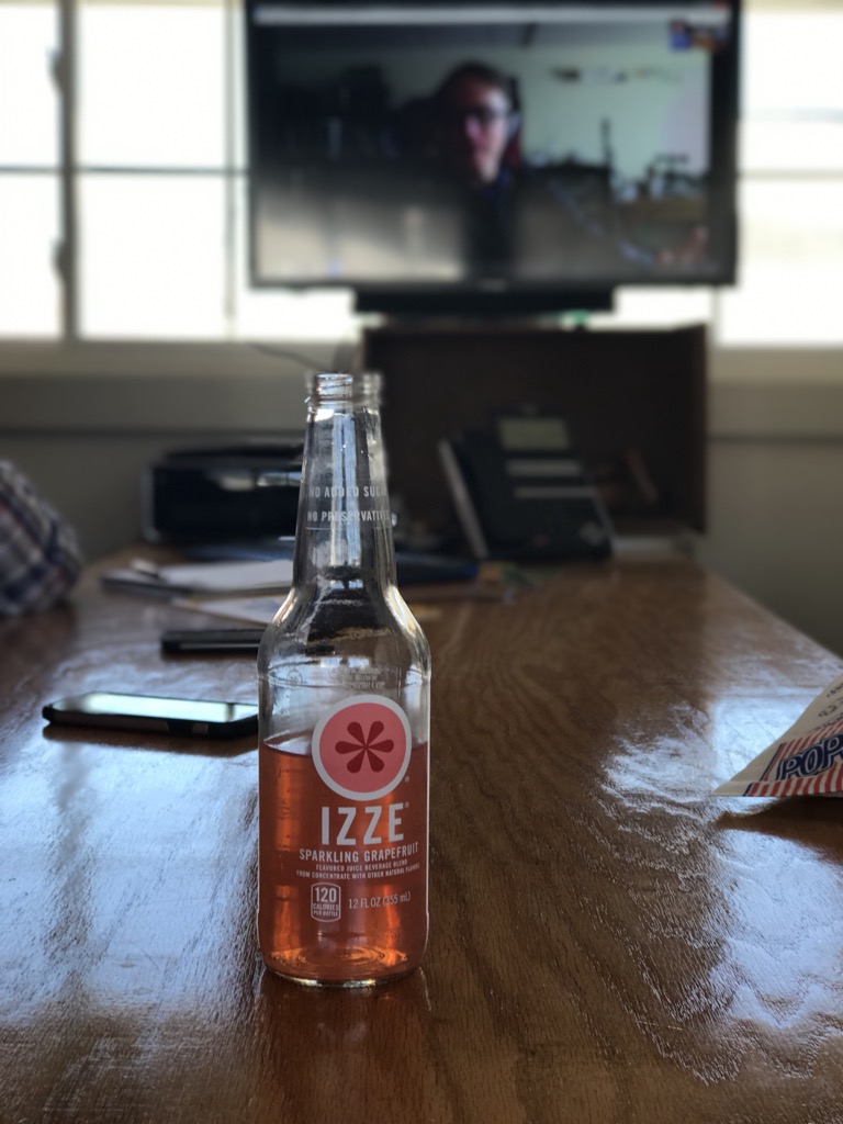 Photo of a soda bottle in iPhone 7S portrait mode, with me in the background.