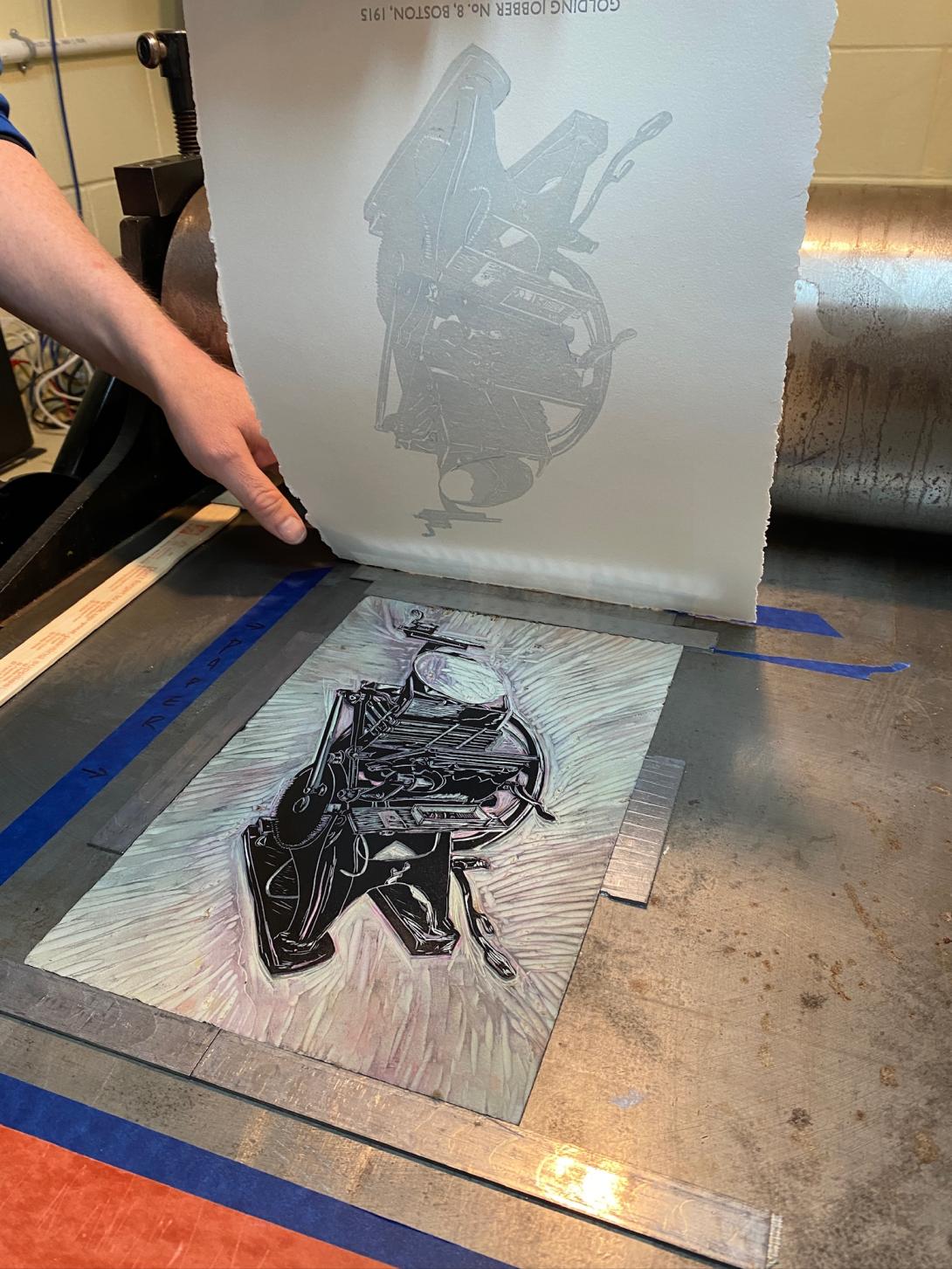 The lino block on the press, having just printed a layer.