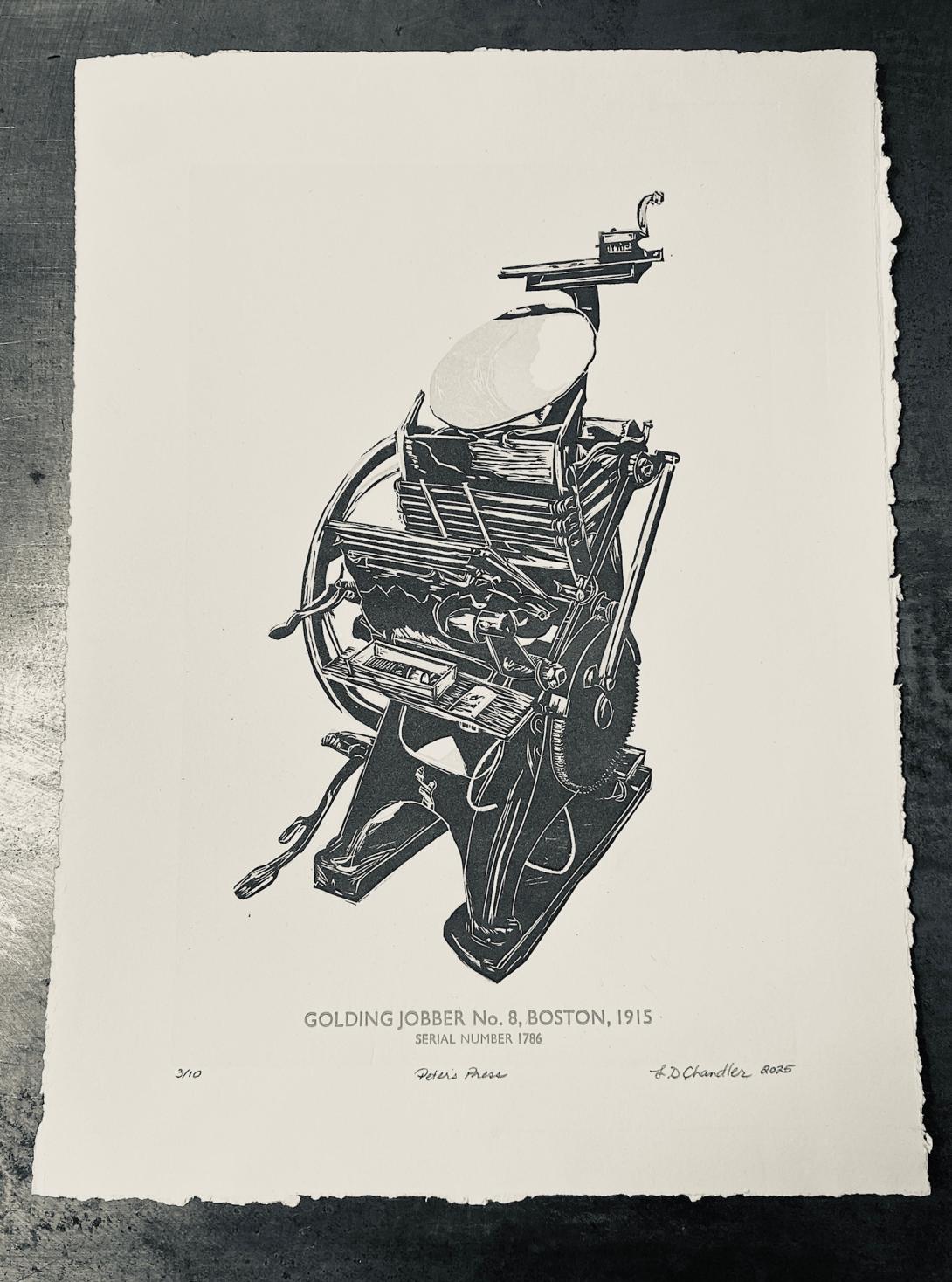 A relief print of a Golding Jobber No. 8 letterpress on cream paper, with a deckled edge, on a black table.