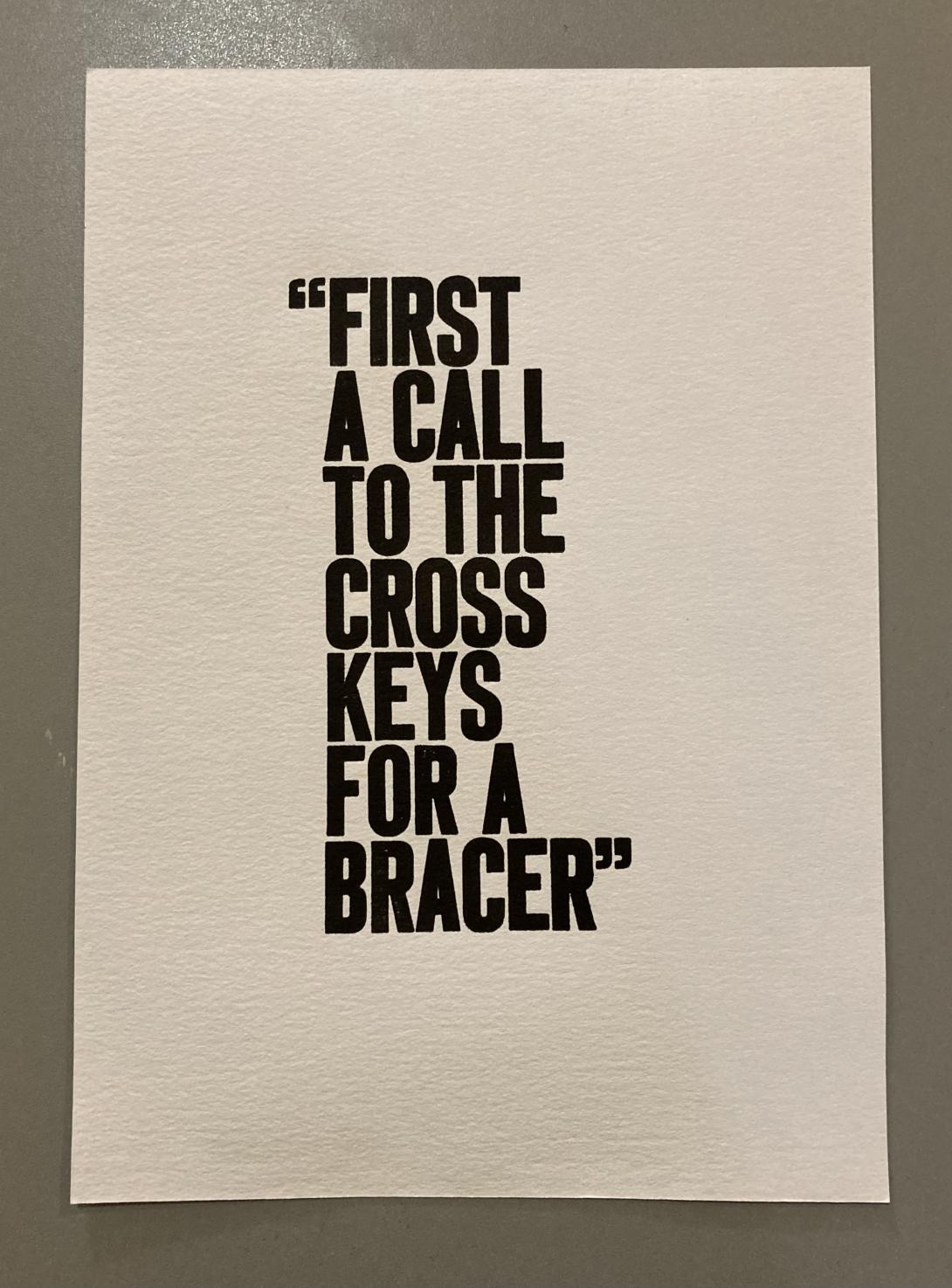 A passage from a Frank Ledwell poem printing in bold dark letters on a piece of white paper.