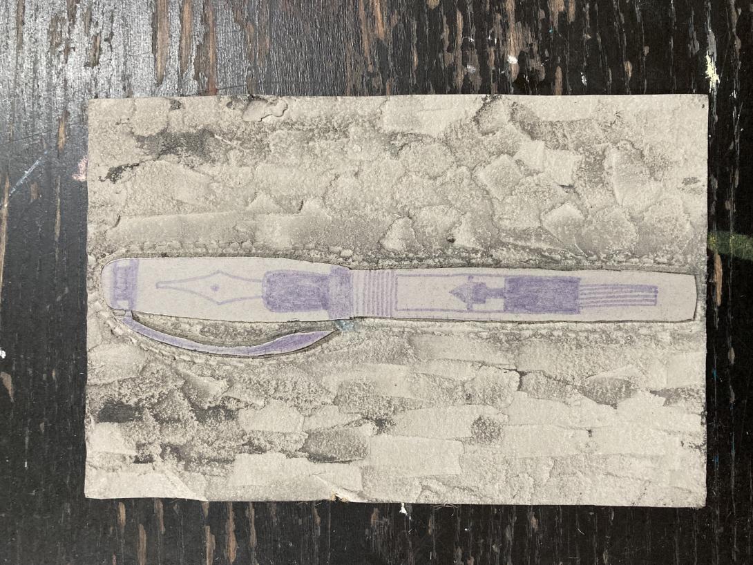 The sketch of the pen transferred to a lino block, and then carved.