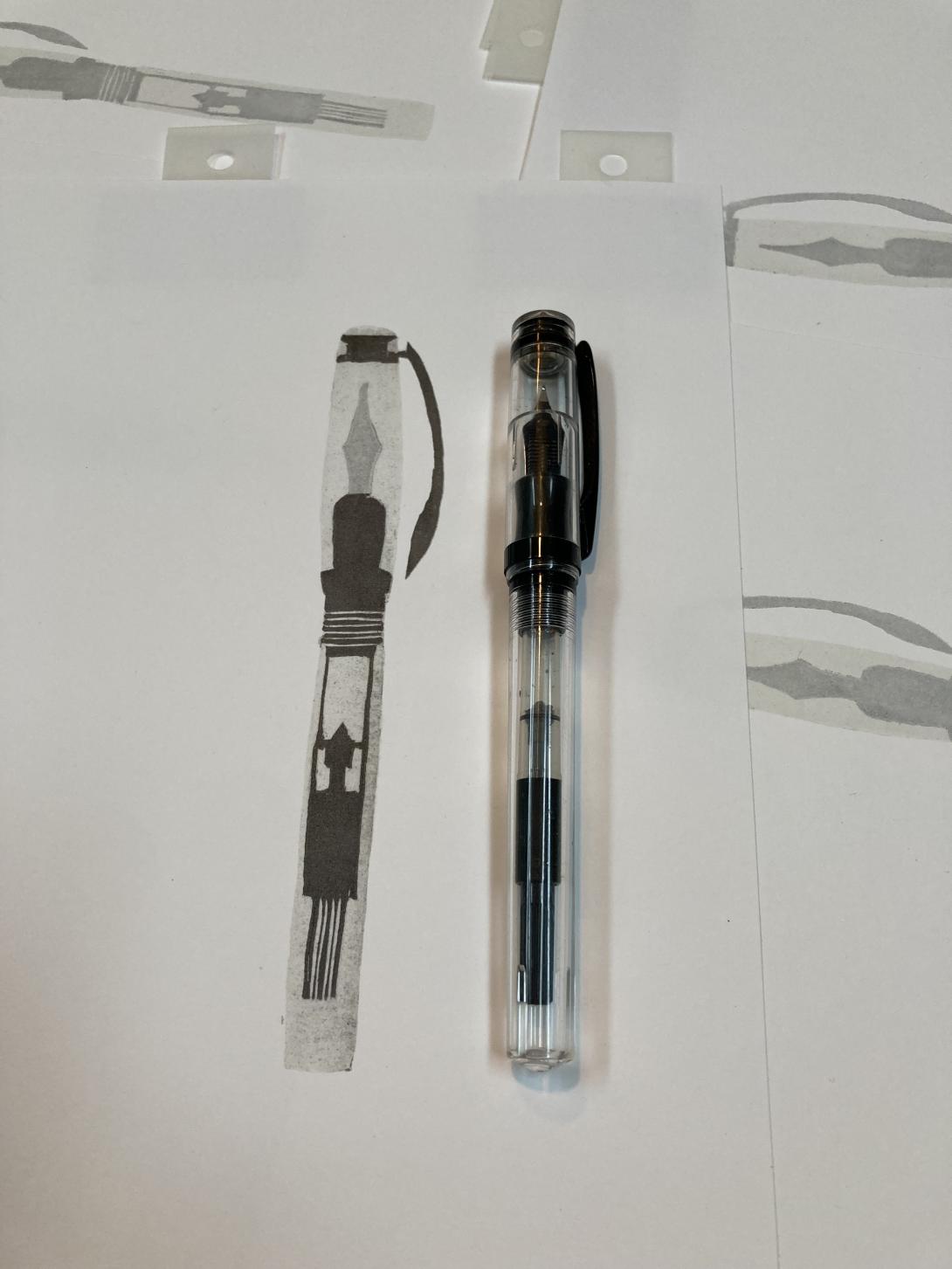 The light, silver, and black layers of the print, with the pen itself for comparison.