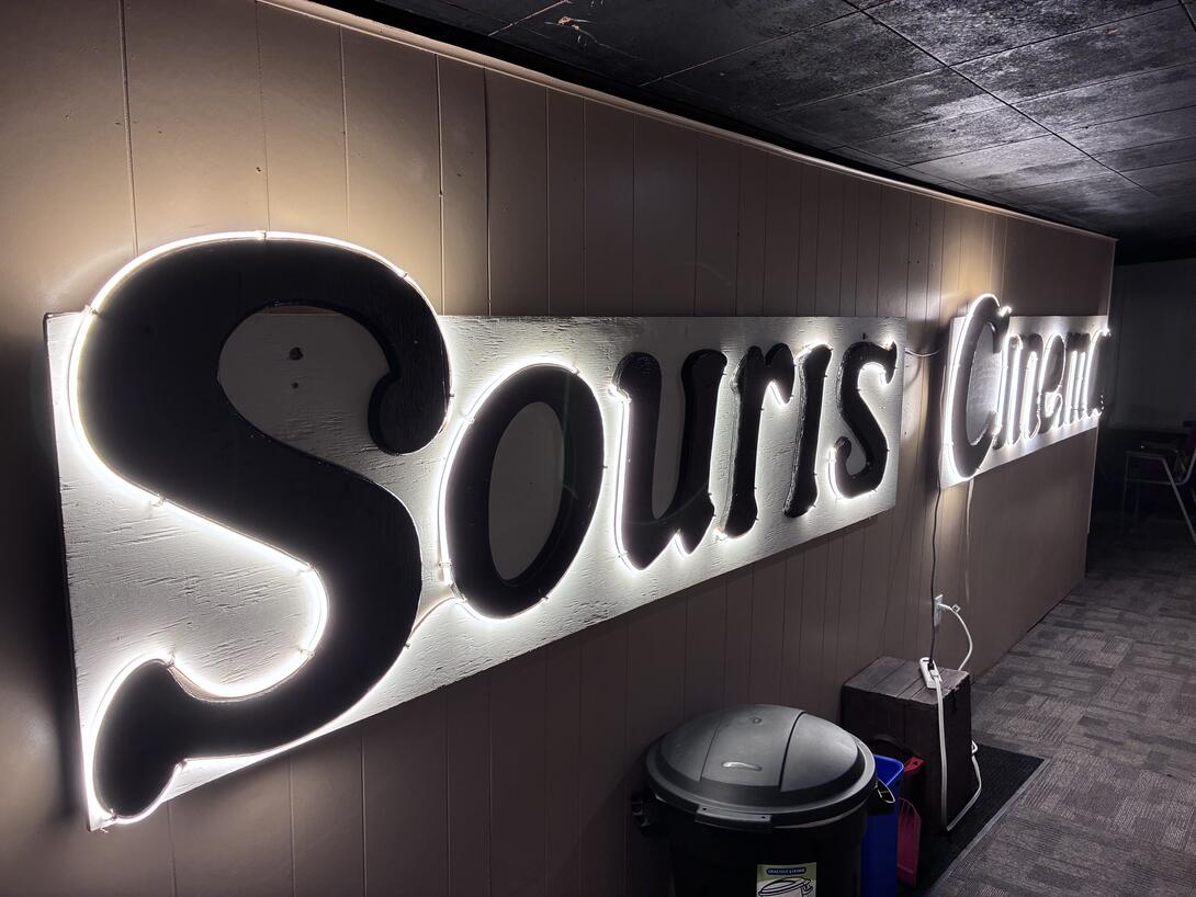 The restored sign for Souris Cinema, lit up inside Souris Show Hall.