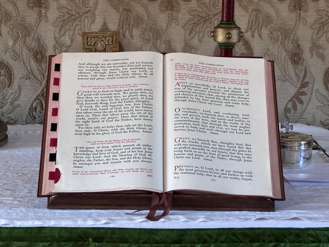 The Book of Common Prayer, open to The Communion page.
