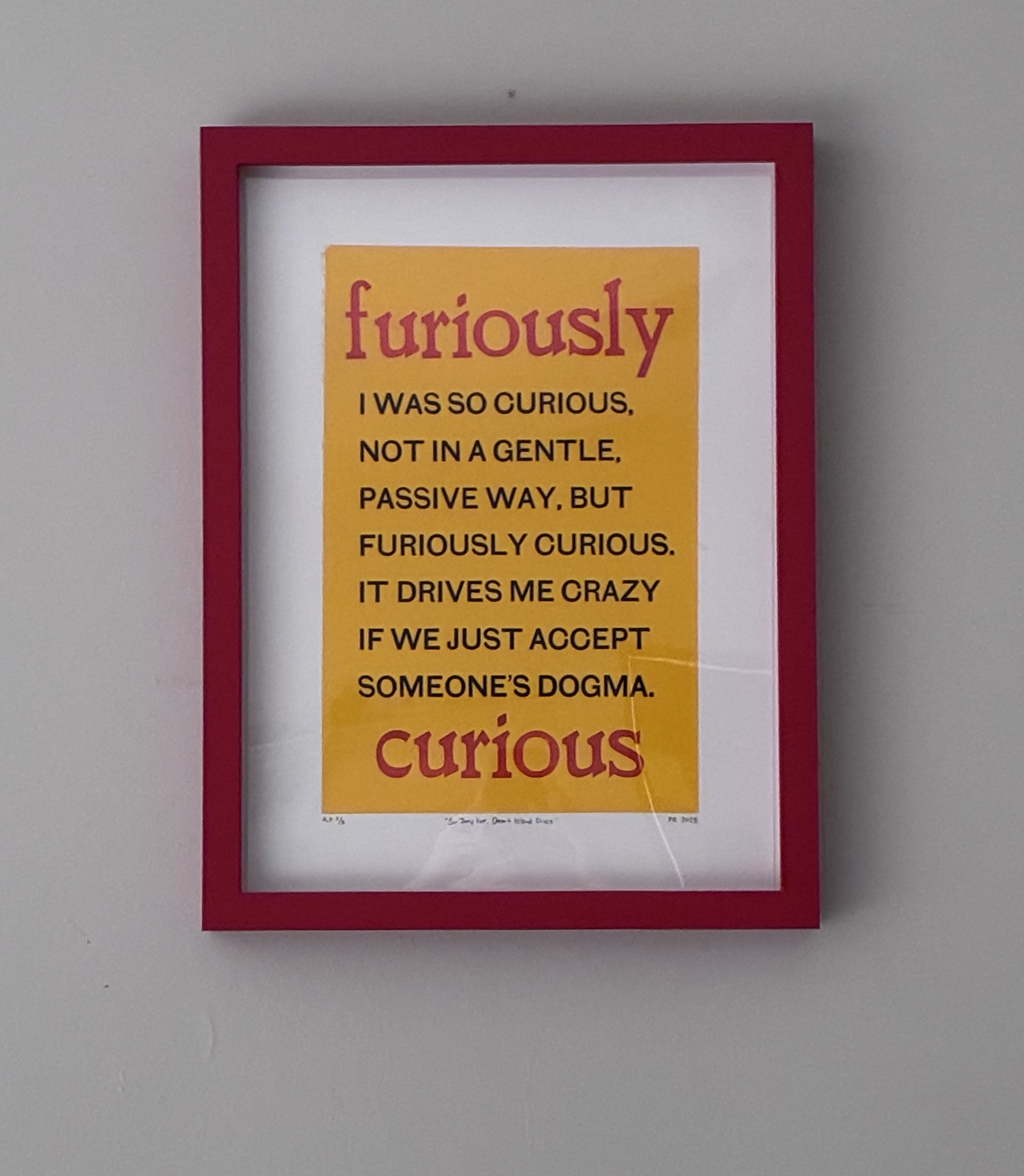 Furiously Curious broadside, framed in red.