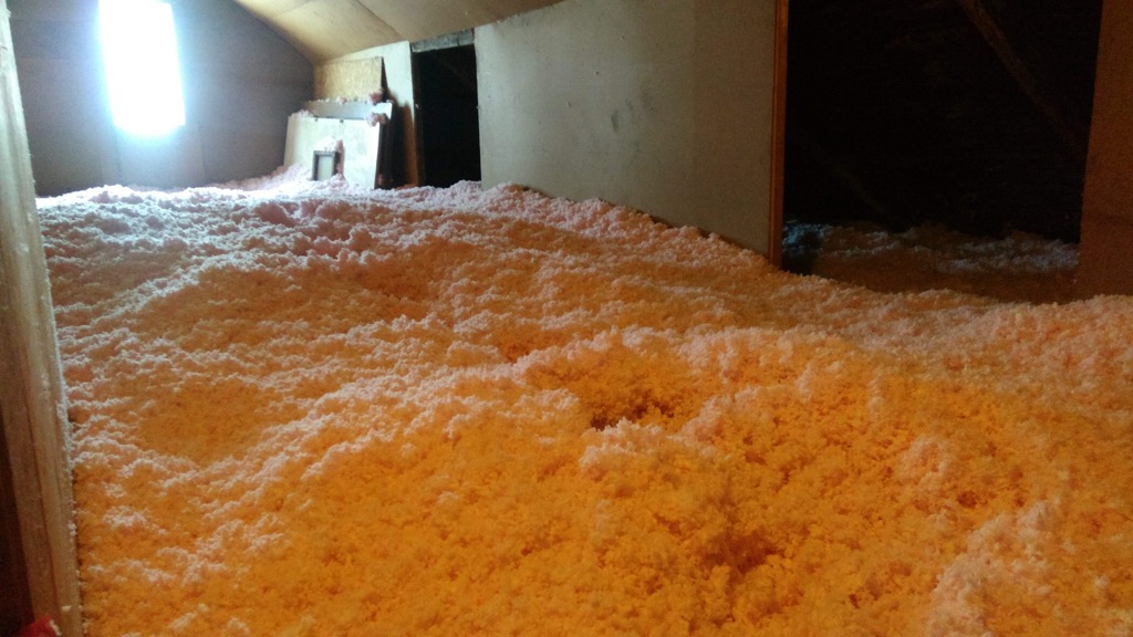 Photo of our attic filled with new insulation.