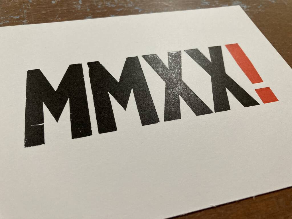 Freshly printed card with MMXX in black and exclamation mark in red.