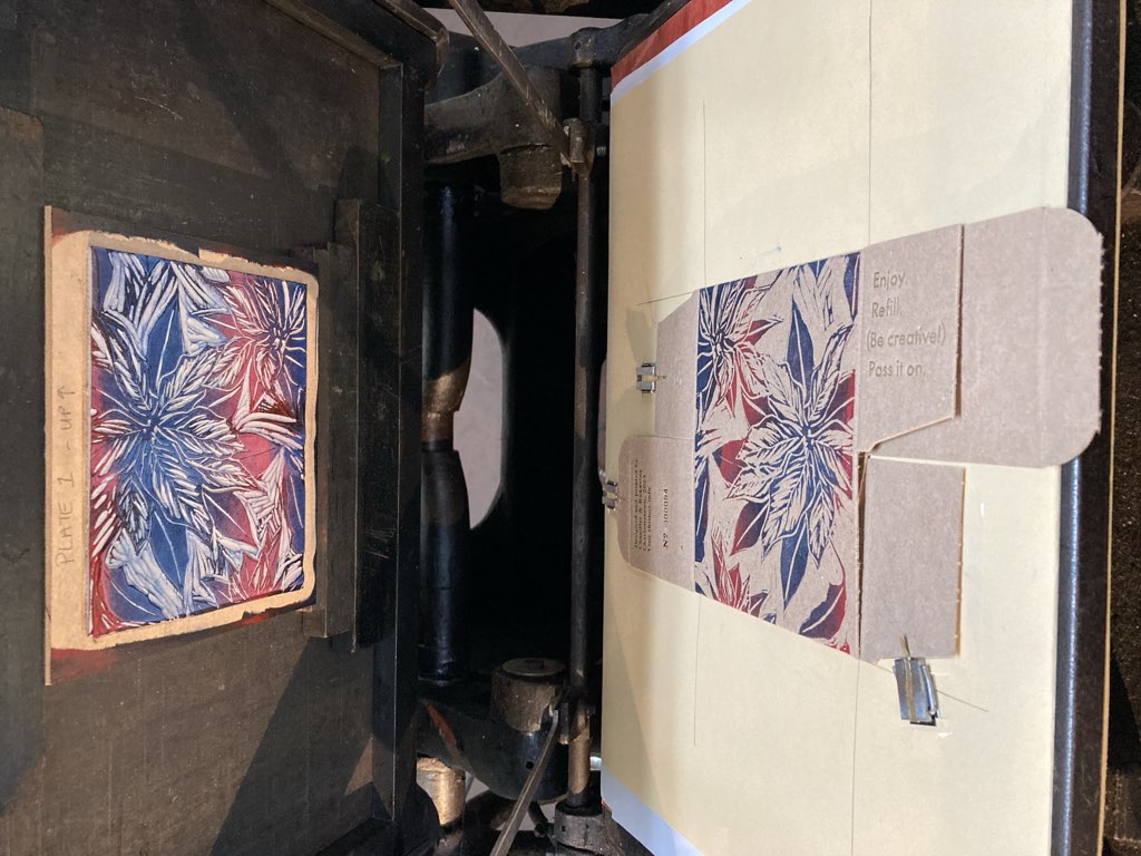 Mounted lino block on the letterpress for printing.