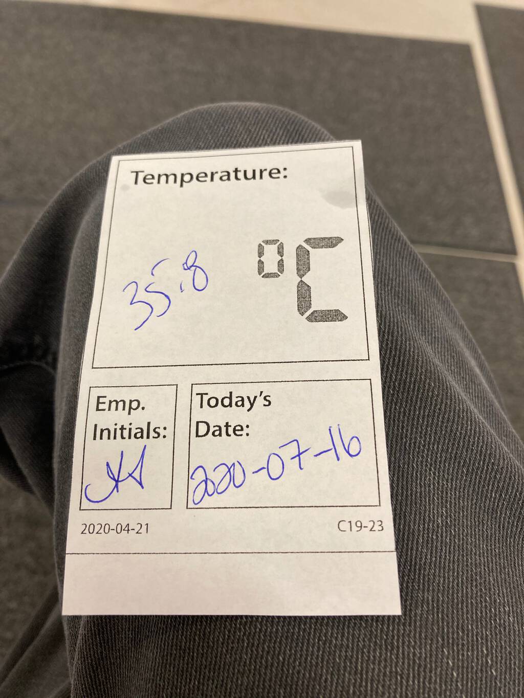 Photo of the chit recording my temperature of 35.8 degrees on arrival.