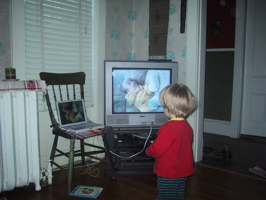 Photo of Oliver looking at a photo of Oliver on the television.