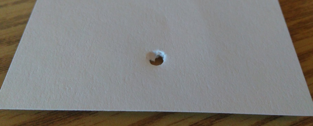 The hole punch in action: a hole punched in a card