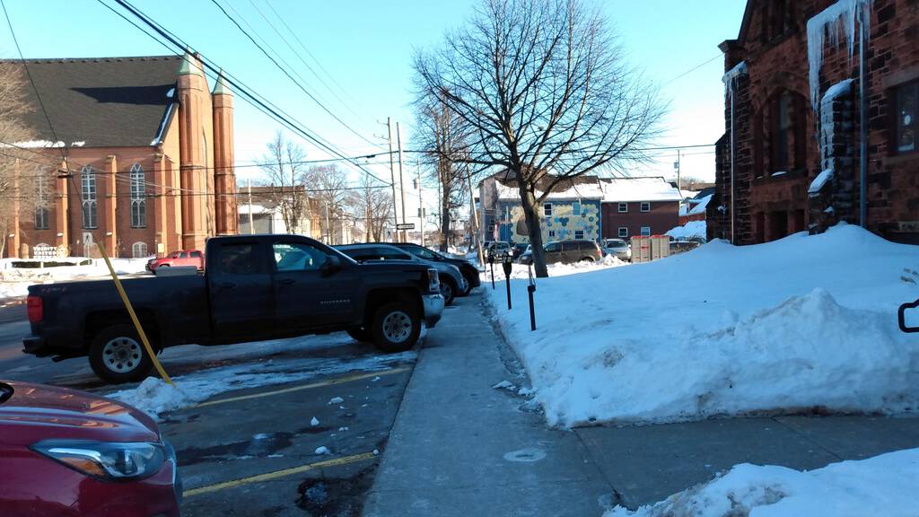 Cars and trucks blocking the Prince Street sidewalk.