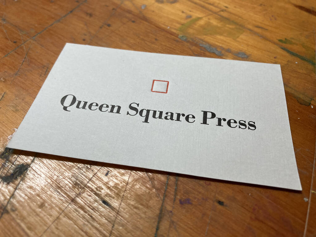 Finished Queen Square Press card, both red and black printed.