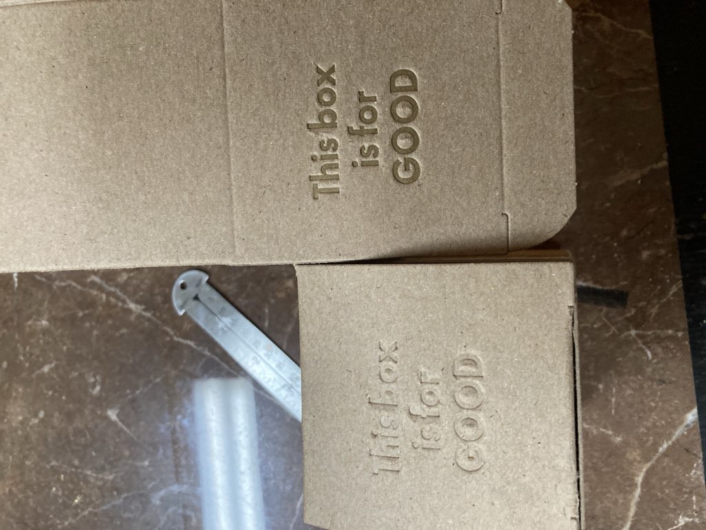 Side by side comparison of printed boxes, with with ink, one without.