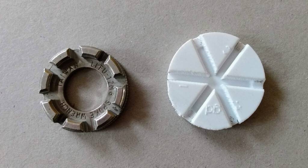 Photo of a metal spoke wrench (left) and my attempt at a 3D printed one (right)