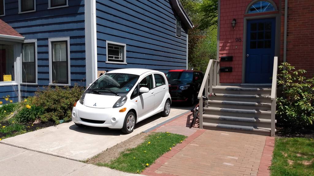 Steve Howard's car from the side, in front of our Kia Soul EV