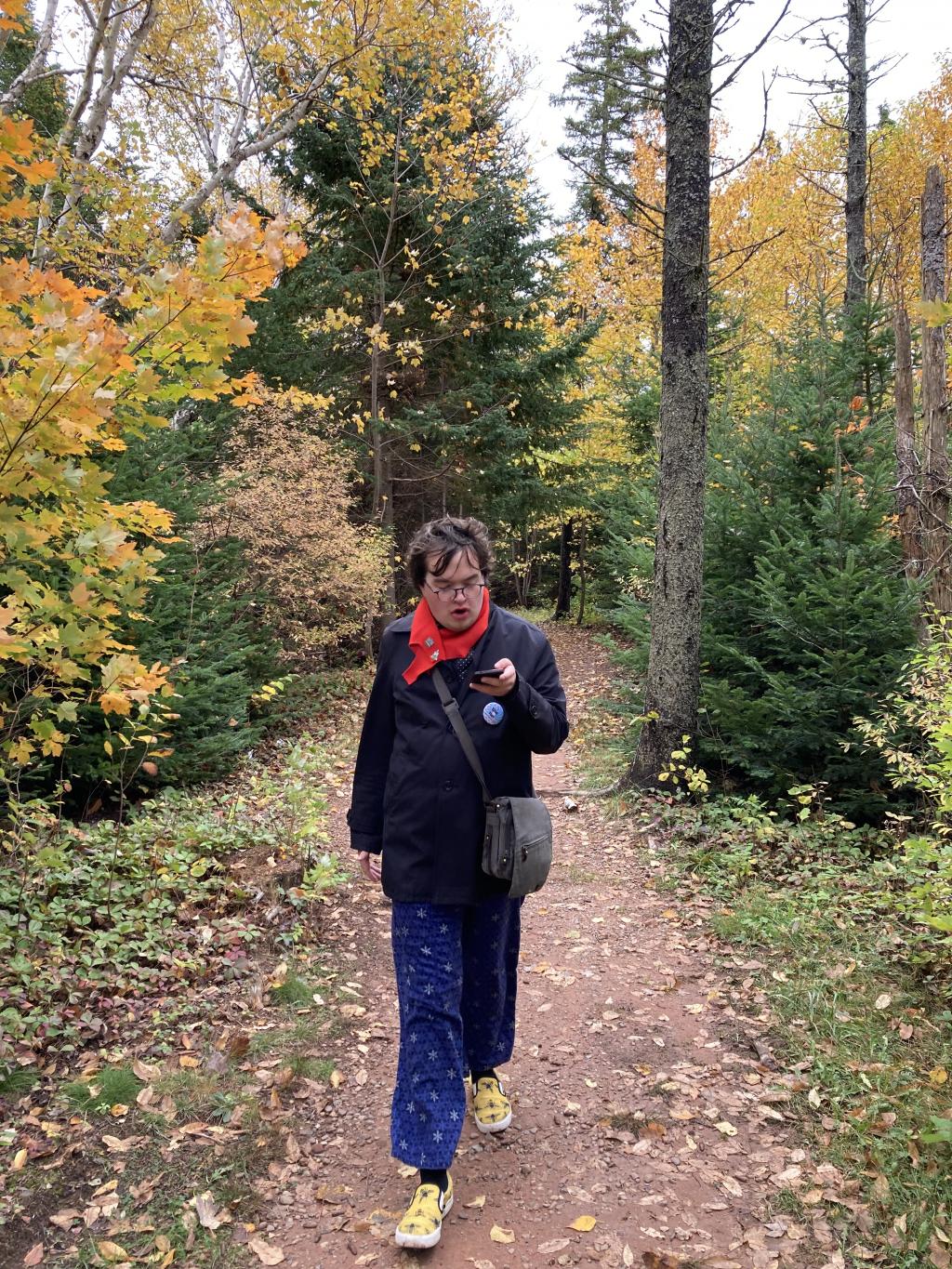 Olivia walking, holding her phone.
