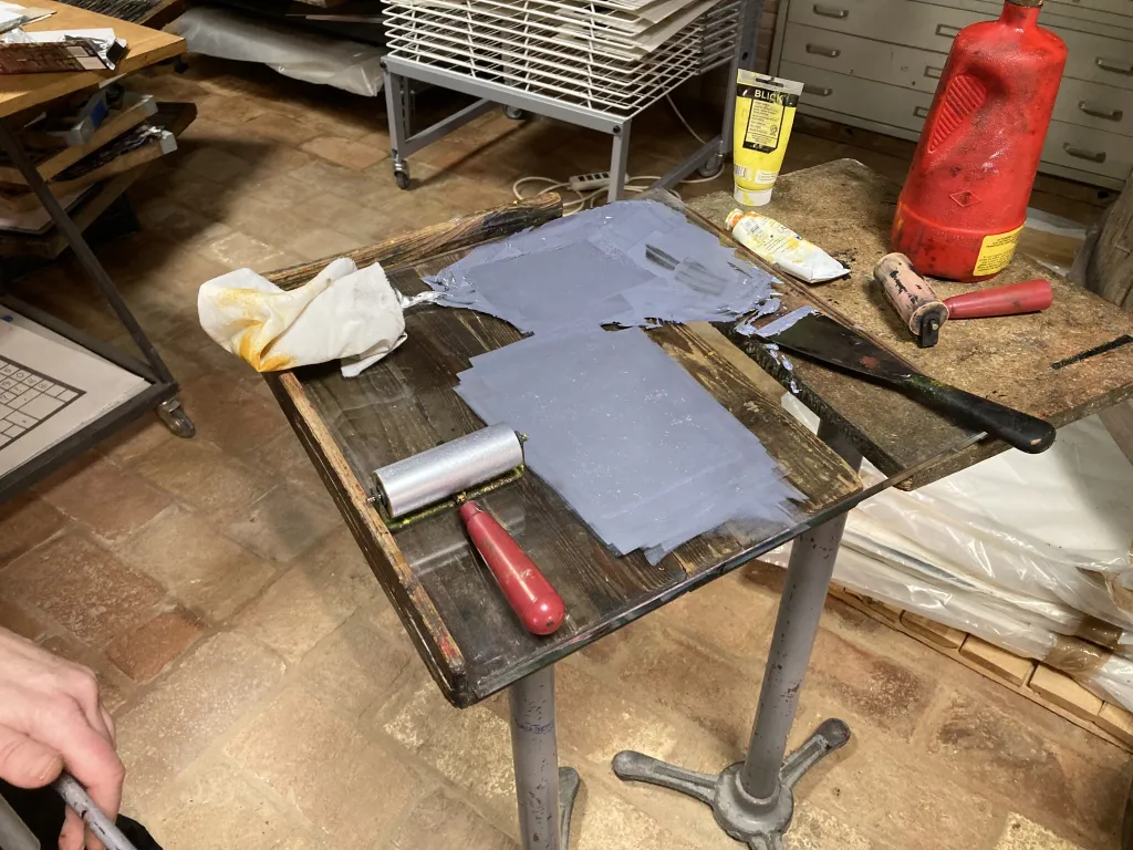 An ink mixing table with silver ink being mixed.