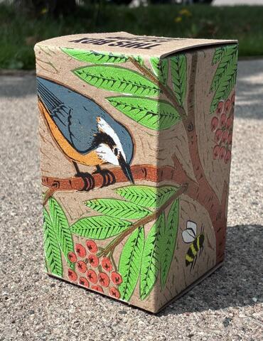 Brown box with a print of a nuthatch on the outside.