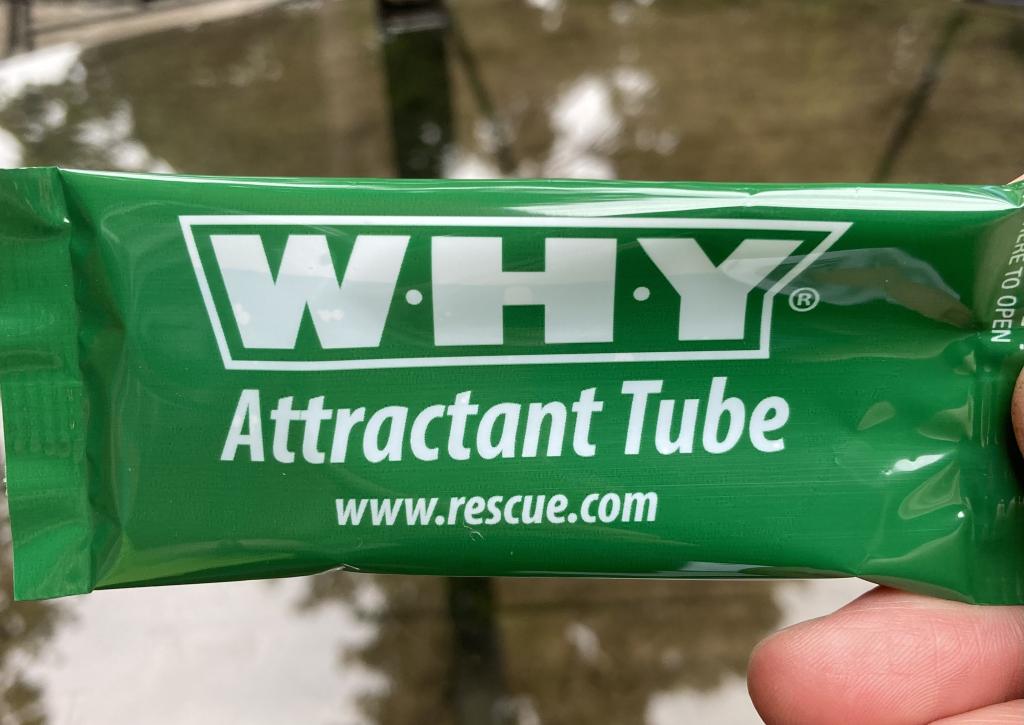 A green tube of wasp attractant, with the URL www.rescue.com and the branding WHY